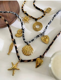 Colgante Cordón Print Charms Sol oro