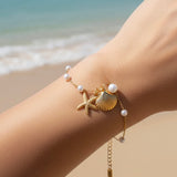 Pulsera estrella de mar y concha perla oro