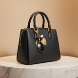 Charm bolso negro oro