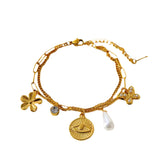 Pulsera charms flores y perla oro
